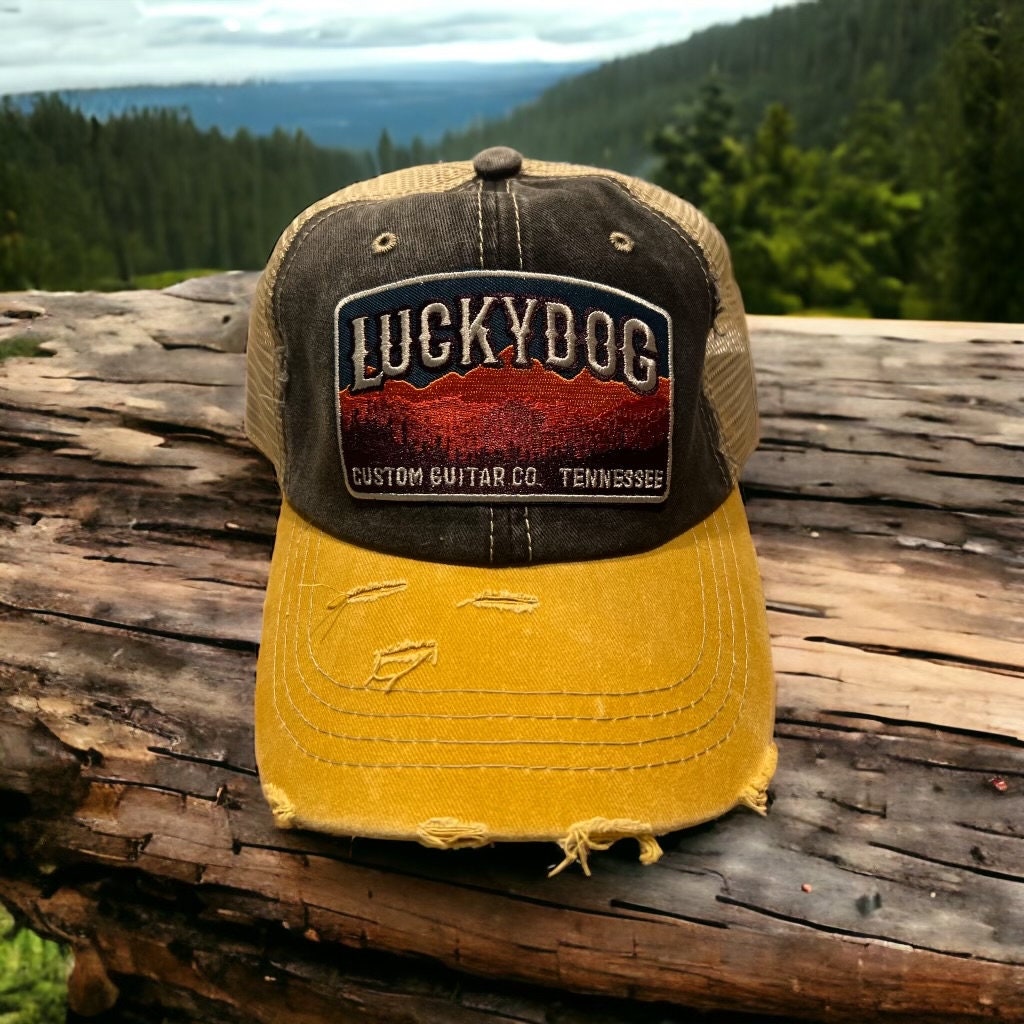 Lucky Dog Guitars distressed low profile Trucker Mesh Ball Cap Hat w/ soft, dark denim crown/gold bill and beige mesh back. Slide buckle